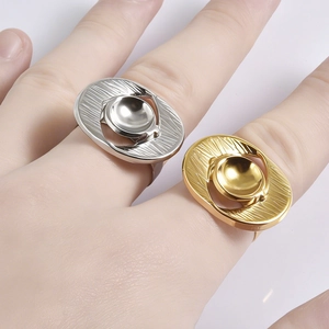 Modernist irregular stainless steel rings with radial texture in gold and silver