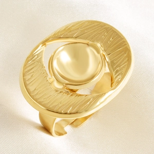 Detail of golden irregular textured open ring with center dome on ivory satin fabric