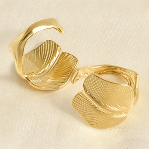 Elegant gold leaf-shaped open ring featuring detailed veins on polished metal surface