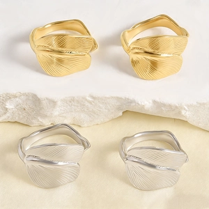Detailed view of leaf pattern engraving and wavy band on stainless steel rings