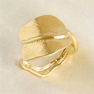 Macro shot of gold ginkgo leaf ring detail showing fine texture and adjustable band