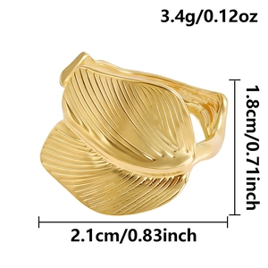 Macro detail of golden stainless steel leaf ring showing vein texture and dimensions