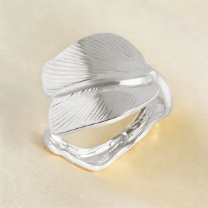 Detailed close-up of a silver stainless steel ring with intricate leaf vein patterns