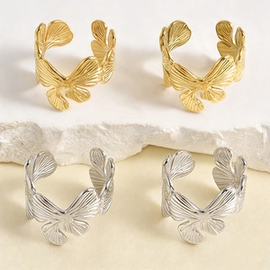 Adjustable stainless steel ring with gold and silver butterfly wing textures on stone base