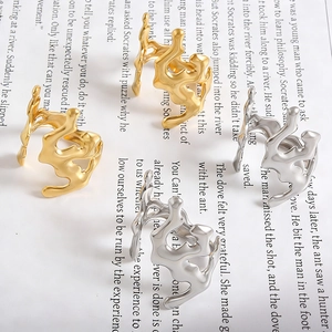 Detailed macro view of irregular molten liquid metal rings in gold and silver finish
