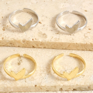 Detail view of fishtail open ring with brushed metal texture in gold and silver