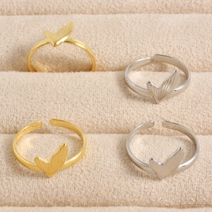Detail view of gold and silver fishtail open rings with brushed metal texture