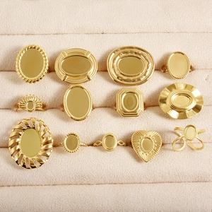 Collection of twelve vintage style gold signet rings displayed on a beige velvet jewelry tray