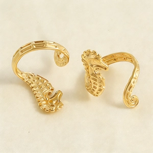 Detailed view of two golden seahorse rings featuring intricate lattice hollow carving work