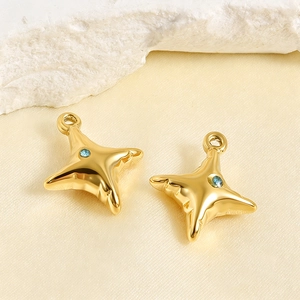 Detailed view of gold stainless steel star pendants with light blue center zirconia