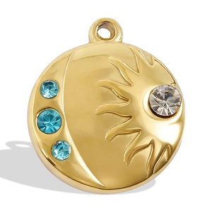 Detailed macro view of 18k gold plated sun and moon pendant with sparkling crystals