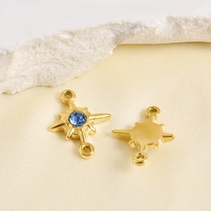 Macro view of gold stainless steel eight-point star pendant with deep blue crystal inlay