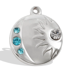 Detailed macro view of sun and moon pendant with blue crystals in polished silver finish