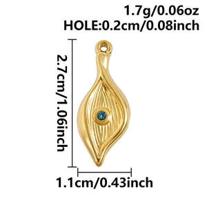 Macro detail of a golden eye-shaped pendant with a blue crystal and dimension markings