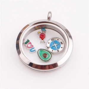 Macro view of round glass floating locket with mini enamel charms inside