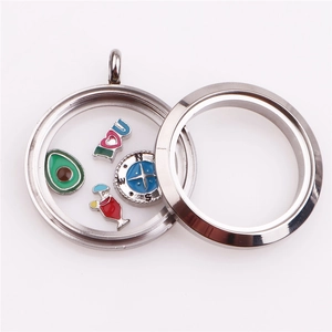 Macro detail of a round stainless steel locket with colorful enamel charms inside
