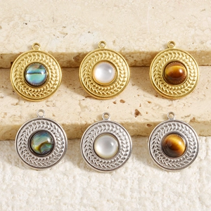 Detail of round 18k gold and silver pendants with shell inlays for DIY jewelry