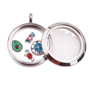 Polished stainless steel round glass locket with colorful inner charms on white background