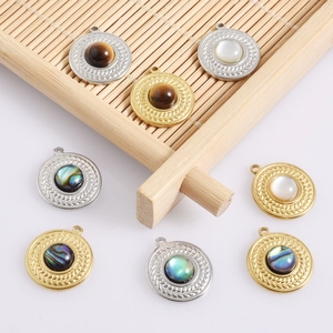 Macro view of 18k gold stainless steel round pendants with natural shell inlays