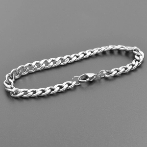Macro detail of silver stainless steel Cuban link necklace with secure lobster clasp