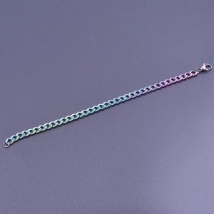 Macro shot of colorful iridescent stainless steel Cuban link chain with lobster clasp