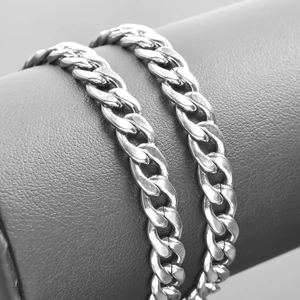 Macro shot of silver stainless steel Cuban link necklace with polished metal texture