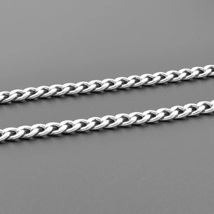 Macro detail of polished silver stainless steel Cuban link chain with mirror finish