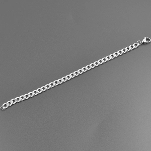 Detailed view of silver stainless steel Cuban link chain with a secure lobster clasp