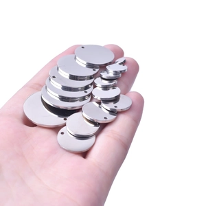 Close-up of assorted stainless steel round pendant blanks for custom DIY jewelry engraving