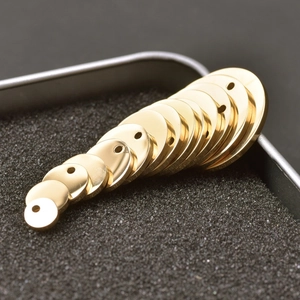 Close-up of gold-plated stainless steel round tags in various sizes for jewelry DIY
