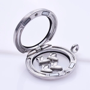 Macro view of magnetic floating locket with silver boots charms in stainless steel locket