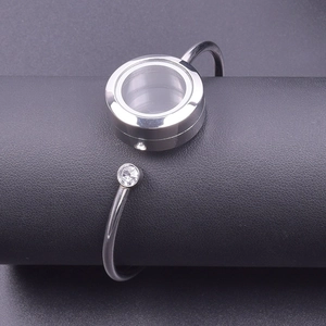 Close-up of 25mm stainless steel locket bracelet with glass window and crystal accent