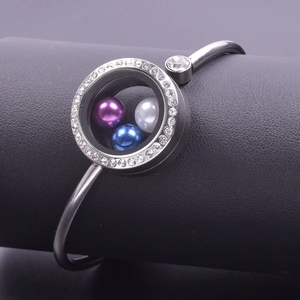 Macro detail of silver stainless steel glass locket bangle with sparkling crystals