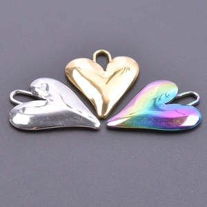 Macro shot of heart-shaped pendants in silver, gold, and rainbow mirror finishes