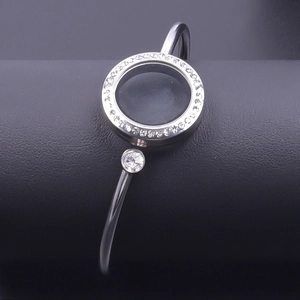 Detailed close-up of 25mm stainless steel locket bracelet with sparkling crystal bezel
