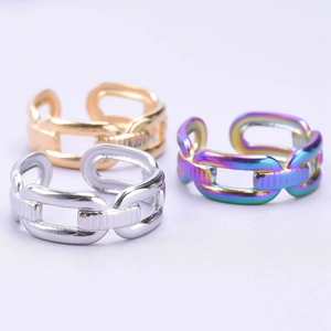 Detailed macro view of three chain-link rings in silver, gold and rainbow finishes