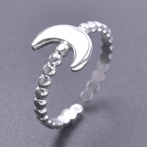 Detailed macro shot of an adjustable crescent moon ring with a beaded band design