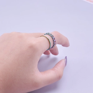 Detail view of rainbow plated stainless steel Cuban chain and thin round ring set
