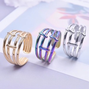 Detailed view of adjustable hollow-out rings in gold, silver, and rainbow finishes