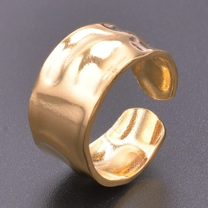 Detailed close-up of golden wide open ring featuring a unique hammered metal texture