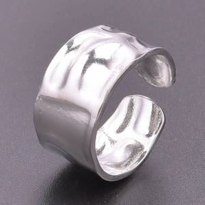Polished silver adjustable open ring with irregular hammered texture on a dark grey surface