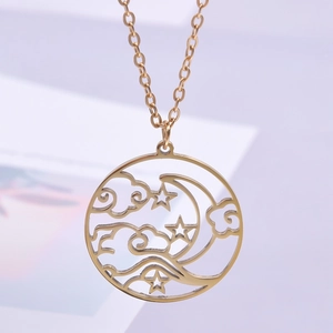 Macro shot of gold celestial necklace with clouds and moon hollow pendant