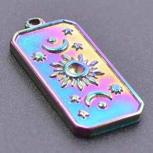 Détail du pendentif en acier inoxydable irisé avec motifs soleil lune et étoiles