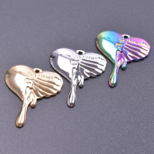 Macro detail of heart lava pendants in gold, silver and rainbow chrome finishes