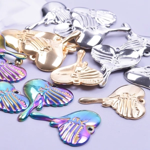 Macro view of heart-shaped stainless steel pendants in gold, silver, and rainbow finishes