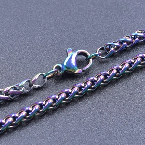 Macro detail of rainbow stainless steel wheat chain necklace with secure lobster clasp