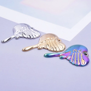 Macro shot of liquid metal heart pendants in silver, gold, and rainbow finishes