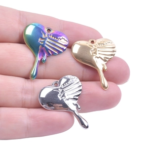 Detailed view of fluid art heart pendants in rainbow, gold, and silver chrome finishes