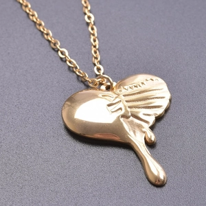 Detailed view of heart pendant necklace with gold lava flow effect and mirror polish finish