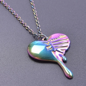 Macro shot of iridescent heart pendant with ribcage detail and molten dripping effect
